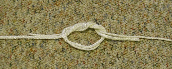 Surgeons-knot-3 Step Three: make a second turn of the materials through the knot.